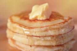 stack of pancakes with butter and syrup
